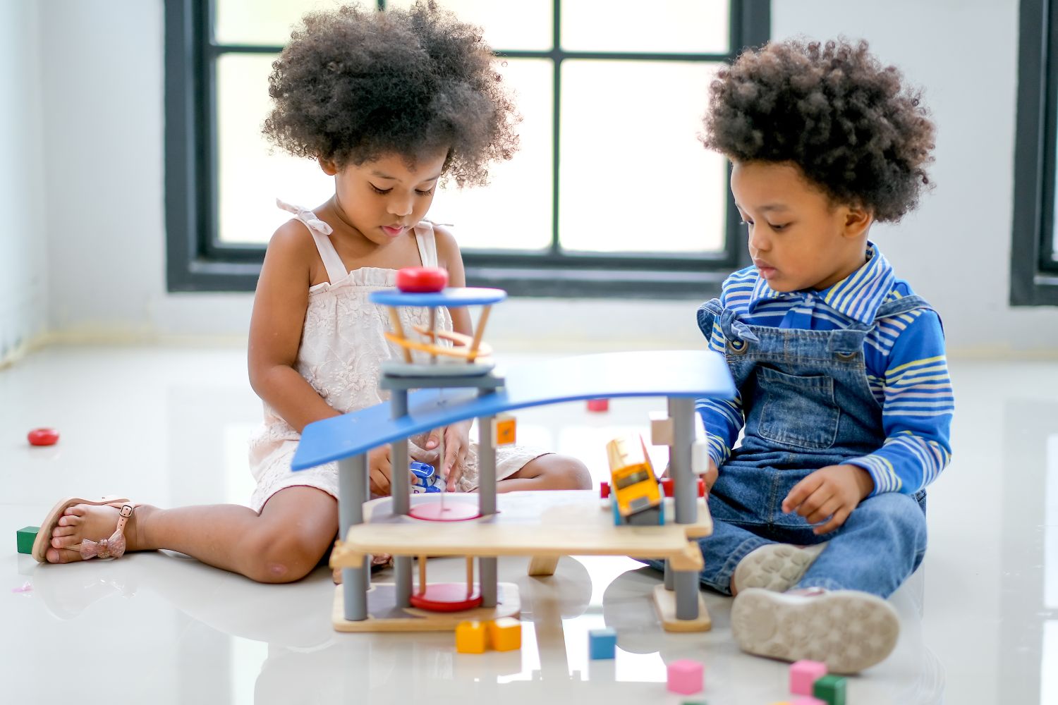 siblings playing with developmental toys